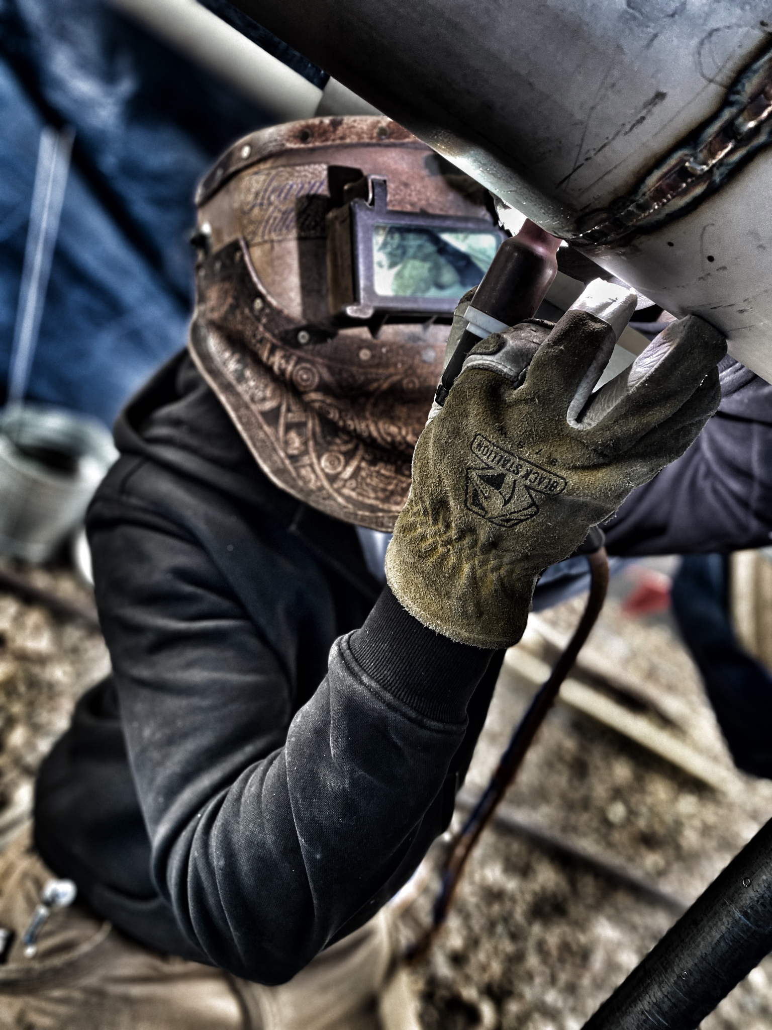Welder TIG welding a stainless steel pipe assembly